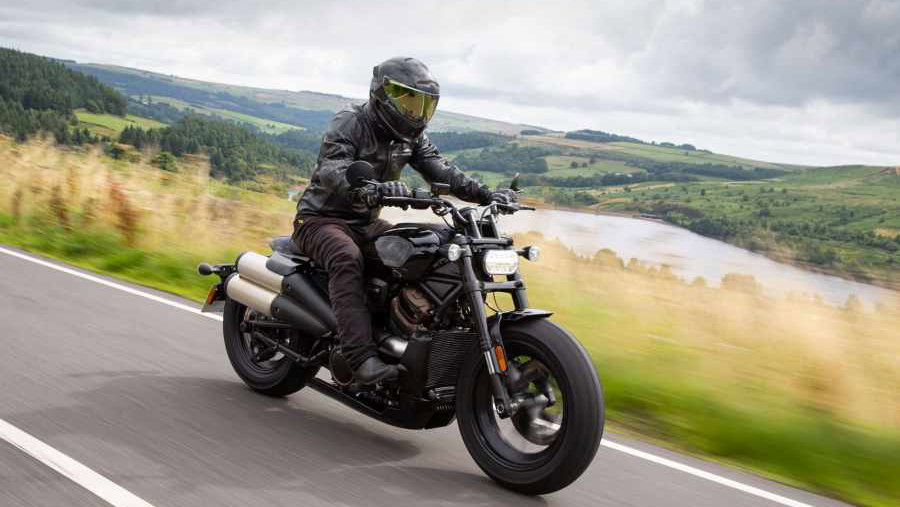A black 2021 Harley-Davidson Sportster S being ridden down a country road